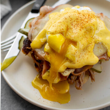 Cuban Eggs Benedict on a plate with a runny egg yolk.