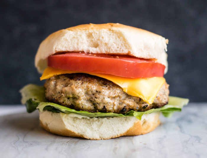 turkey burger with cheese, lettuce and tomato