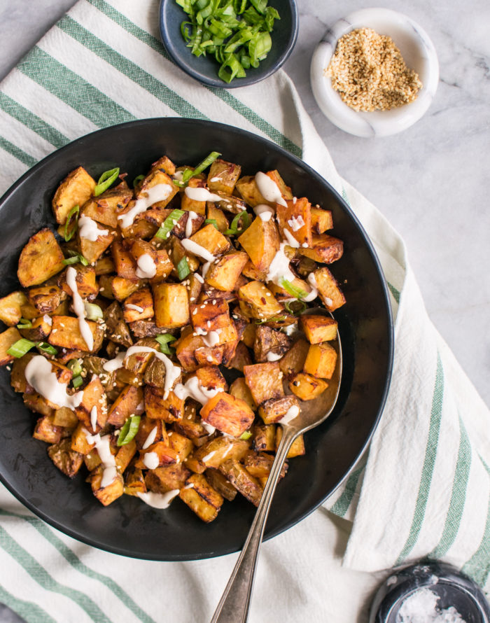 Potatoes roasted with harissa and drizzled with tahini sauce