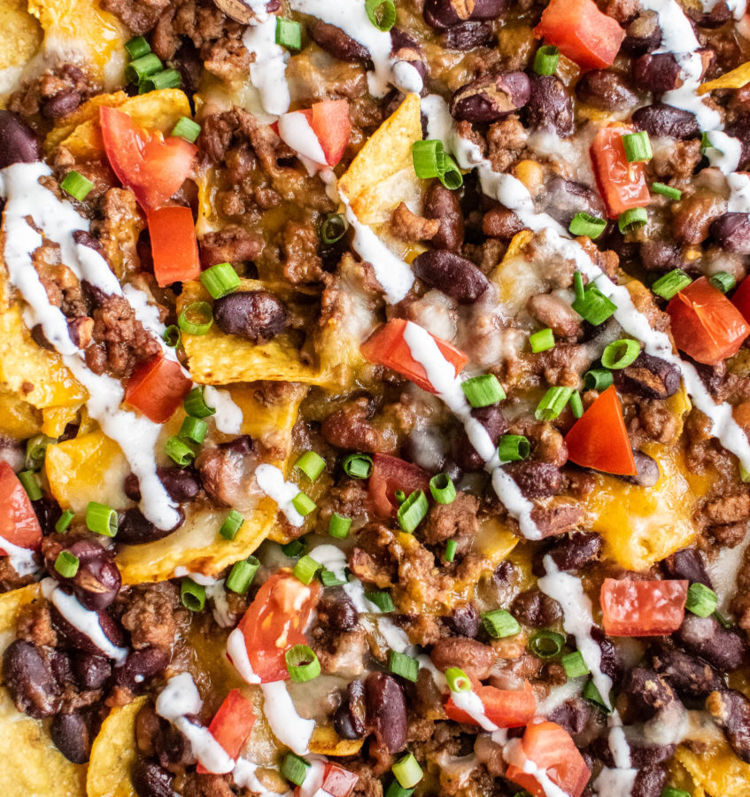 Close up of baked chili nachos.