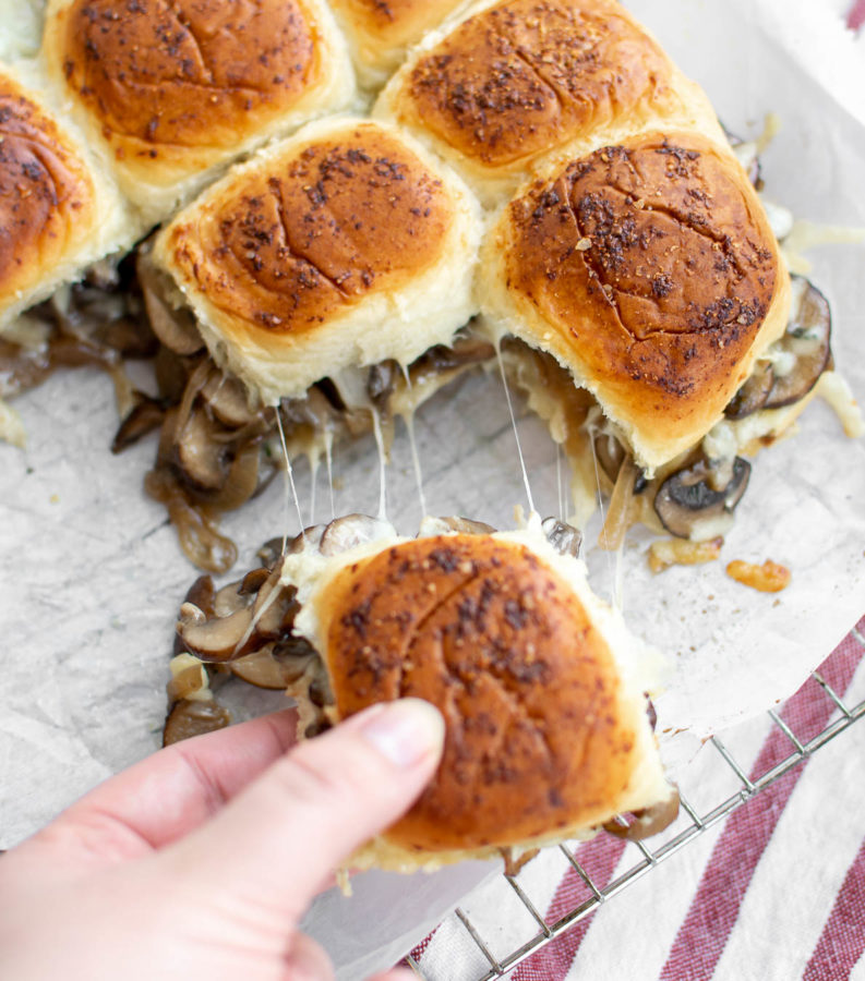 Vegetarian Cheesy Mushroom Sliders being pulled apart.