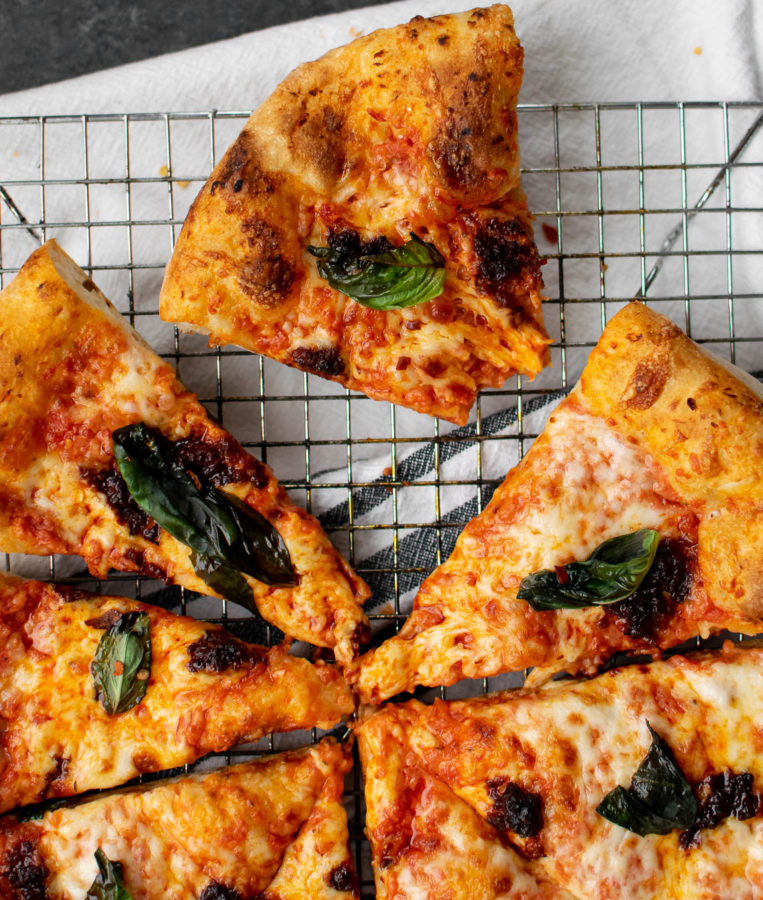 Pizza with 'Nduja and Tomato Cream Sauce cut into slices.