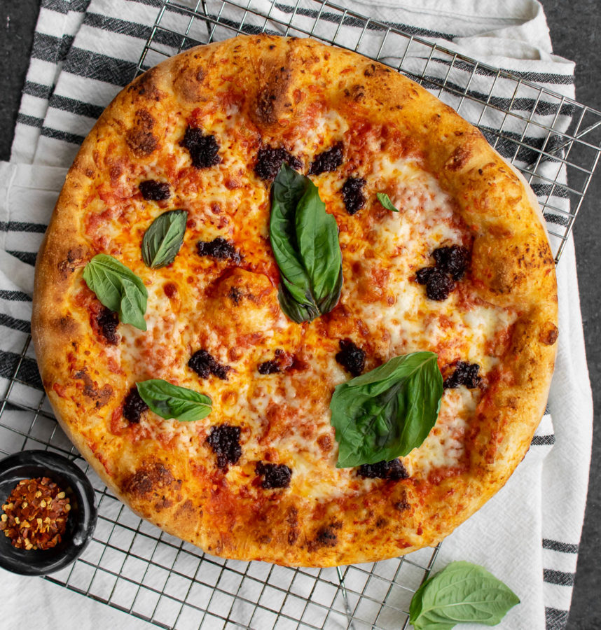 Pizza with 'Nduja and Tomato Cream Sauce and fresh basil on top.