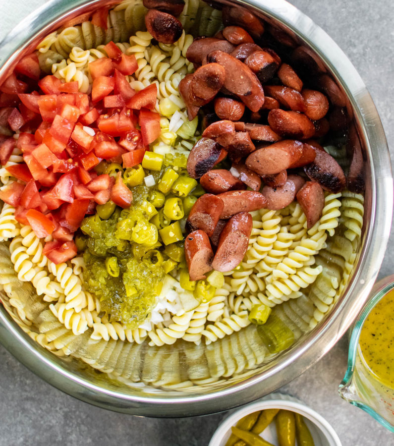 Chicago Hot Dog Pasta Salad ingredients in a mixing bowl.