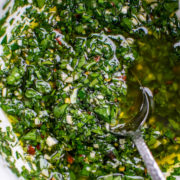 Chimichurri in a bowl with a serving spoon.