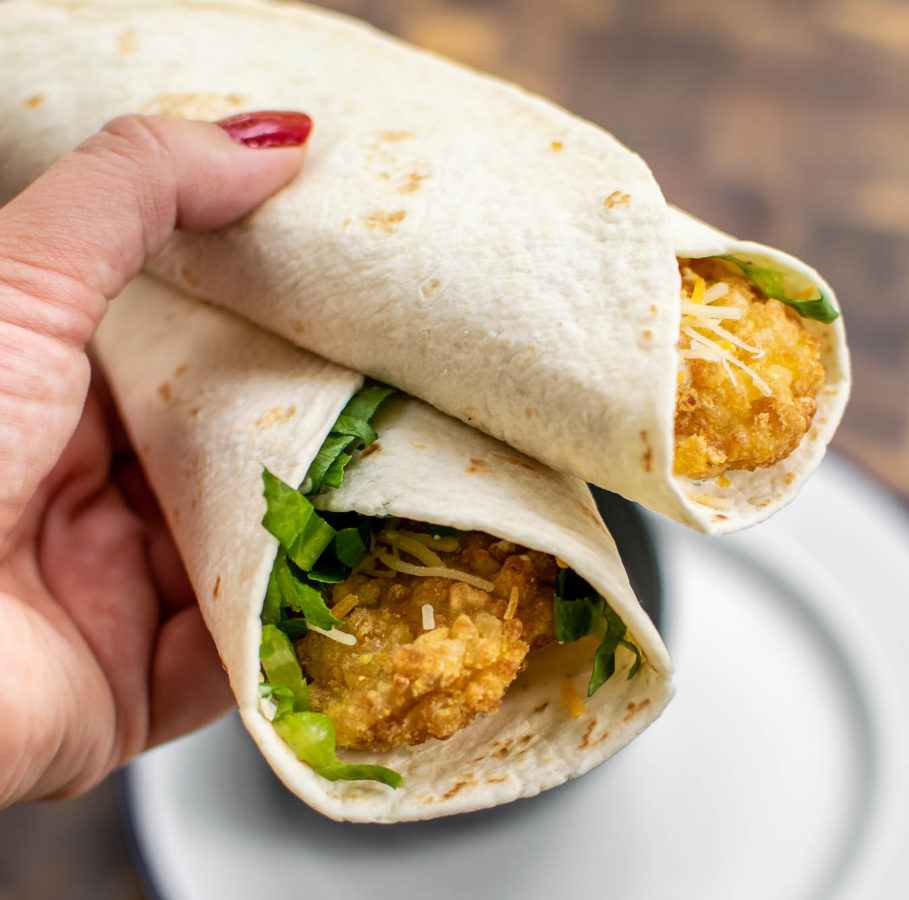 A hand holding two Crispy Ranch Snack Wraps.