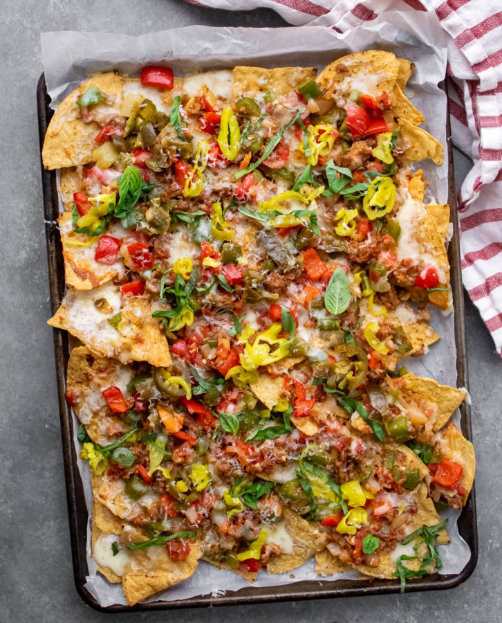 Italian Sausage and Pepper Nachos with toppings.