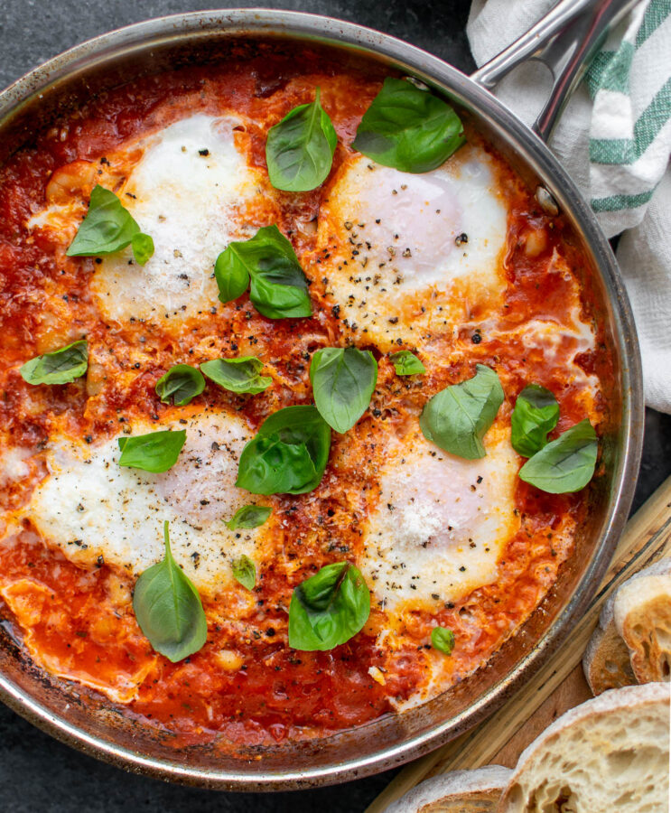 Eggs in Purgatory with White Beans in a pan. Served with toasted bread.