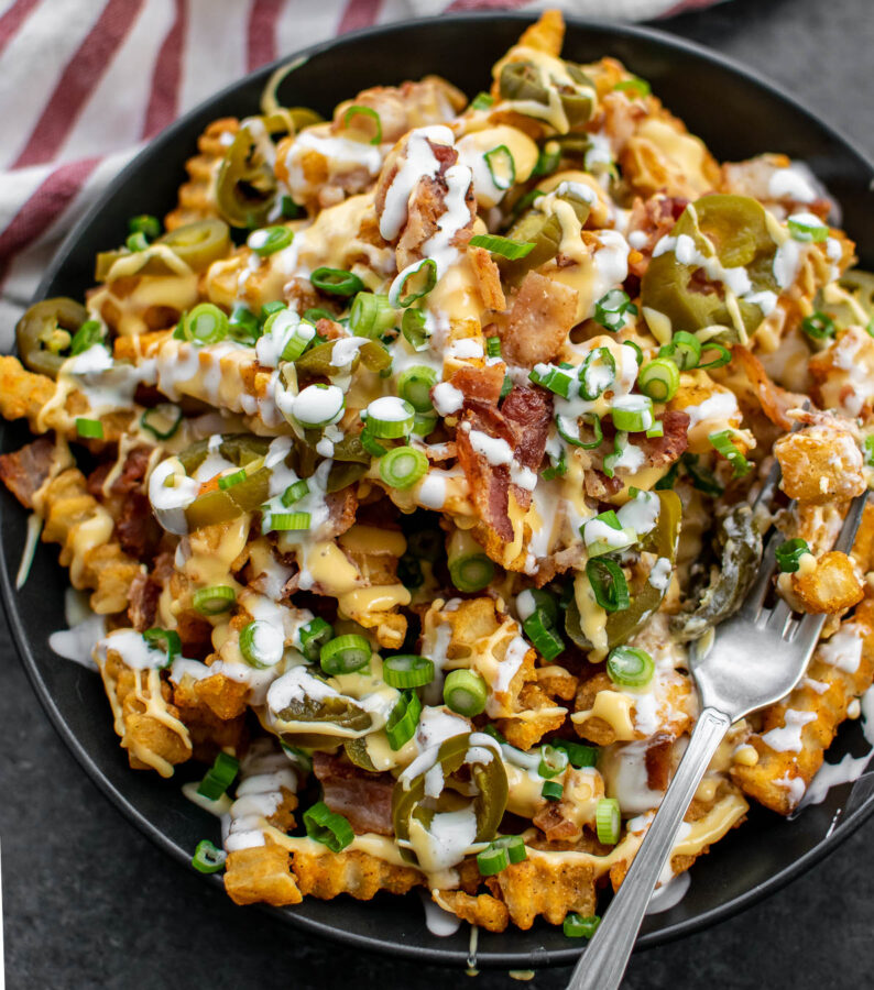 Easy Loaded Bacon Cheese Fries in a bowl with a fork.