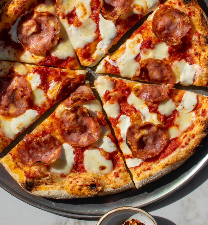 Pizza Diavola with Hot Soppressata sliced on a pizza plate.