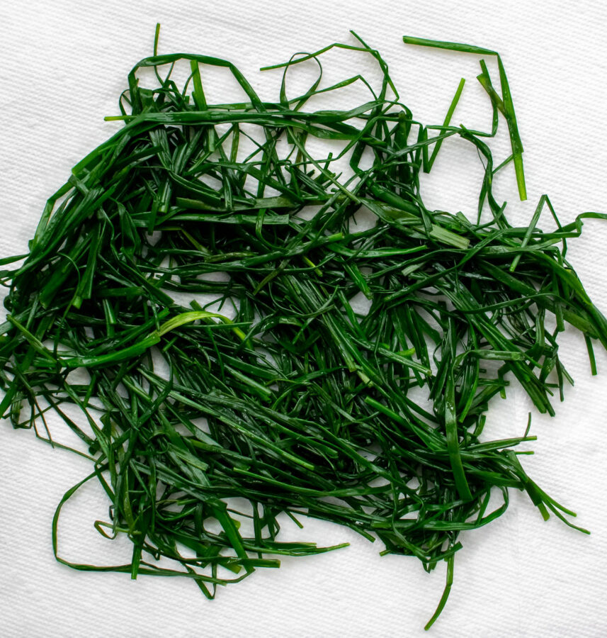 Chives draining on a paper towel.