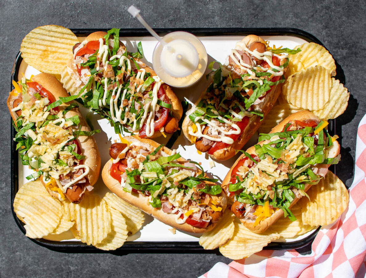 Club Hot Dogs on a serving platter with potato chips.