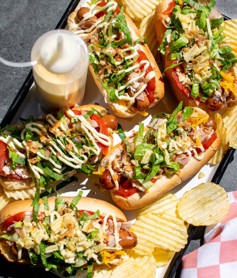 Club Hot Dogs on a serving platter with potato chips.