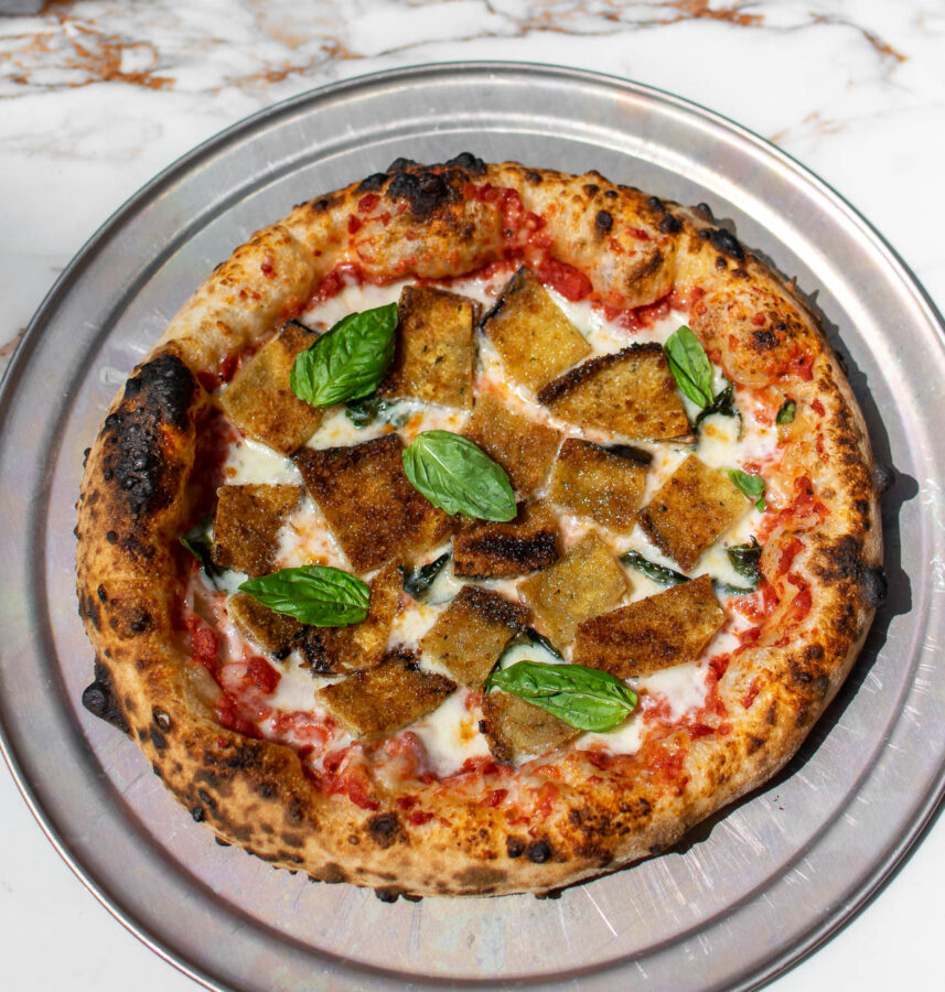 Fried Eggplant Parmesan Pizza on a pizza pan.