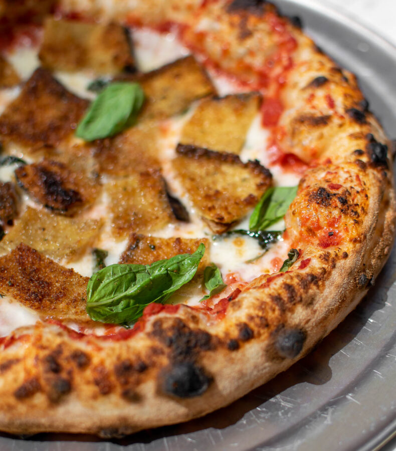 Fried Eggplant Parmesan Pizza close up shot of crust.